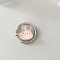 Detail of pink resin bunny phone ring holder with silver metal base on a grey surface - Party Rabbit