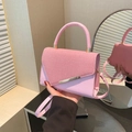 Pink textured crossbody bag with gold accents and stylish top handle for summer - Pink
