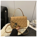 Detail of khaki quilted crossbody bag featuring a black and gold metal twist lock - Khaki