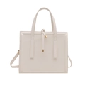 Minimalist square tote bag in off-white finish with gold hardware and dual handles - White