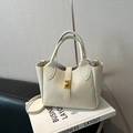 Elegant cream lychee grain leather bucket bag with top handle and crossbody strap - White
