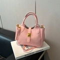Elegant pink women's handbag featuring a lychee pattern and gold-tone twist-lock closure - Pink Without Charm
