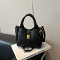 Elegant black pebbled leather bucket handbag with gold hardware and top handles - Black