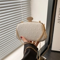Elegant ivory fabric clutch bag with dotted texture and diamond-set gold metal clasp - White