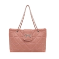 Pink quilted tote bag with silver bow accent and woven chain straps on white background - Red