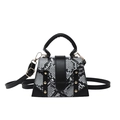 Chic snake-pattern crossbody bag with gold studs and removable strap on white background - Black