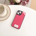 Close-up of rose red litchi leather iPhone case with 3D bow and goodluck tag on a table - Rose Red