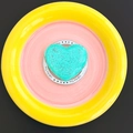 Top view of a bright teal heart-shaped bath bomb on a Gift For You paper base - Magnetic Gift Style - Green