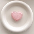 Detailed macro of pink glitter heart phone socket grip with sparkling sequins on a white tray - 3D Airbag Style - Pink
