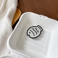 Detail of cute fish-shaped phone grip and mirror accessory inside a creative gift box - Black
