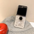 Detail of glitter Z Flip case with black sphere ring stand next to a red apple - Matte Hard Case-Silver Foil Heart-Ball Ring-Black / Samsung ZFold3