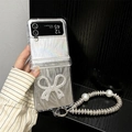 Detail of glitter flip phone case with large rhinestone bow and pearl charm bracelet - Large Rhinestone Butterfly (Feather Paper + Large Pearl Diamond Chain) / Samsung ZFlip3