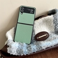 Detail view of mint green lychee leather case for Z Flip 6 on a plush bag surface - Green
