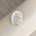 Close-up of silver metal phone grip with blue dried flowers and silver foil flakes - Oval Real Flower-Silver Foil Three Hydrangeas