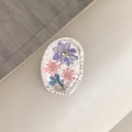 Detail of flower phone grip with silver foil and real pressed petals in resin - Oval Real Flower-Silver Foil Purple Larkspur
