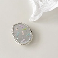 Macro view of oval glitter phone grip featuring colorful musical notes and silver metal frame - Starry Sky Music White