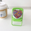 Detail of glitter heart MagSafe phone grip on a mini green chair stand with Gift For You text - Mixed Color Sequins