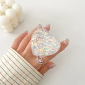 Close-up of heart-shaped glitter phone grip and matching pink gemstone ring on hand - Transparent Stand - 3D Heart - Shell Fragments