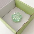 Macro shot of green glitter resin cat paw phone grip inside a light green gift box - Green