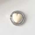 Macro detail of heart-shaped phone ring holder with cream heart and silver metal frame - Fat Heart / White