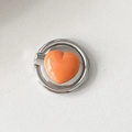 Detail view of the orange heart shaped mobile phone ring holder with silver metal finish - Fat Heart / Orange