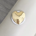 Dettaglio del supporto MagSafe a cuore dorato metallizzato con bordi plissettati - Cuore a Palloncino Metallico / Oro