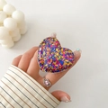 Macro shot of heart-shaped glitter phone grip featuring colorful sequins in clear resin - Transparent Stand - 3D Heart - Mixed Color Dots
