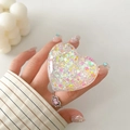 Detail of a transparent heart-shaped phone grip with iridescent glitter and star sequins - Transparent Stand - 3D Heart - Heart Fragments
