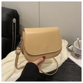 Detail of light apricot saddle bag with silver engraved logo and adjustable strap - Khaki