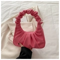Dettaglio della borsa a mano rosa plissettata a mezzaluna con texture in pelle a grana - Rosa
