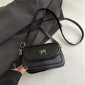 Elegant black small square crossbody bag with golden bow detail and shoulder strap - Black