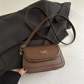 Stylish minimalist brown crossbody saddle bag with elegant gold bow accent for women - Brown