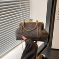 Elegant vintage-style shell clutch bag with gold chain strap and dark glittery fabric texture - Black