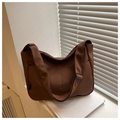 Detail of dark brown nylon crossbody bag featuring an adjustable wide strap and side label - Brown