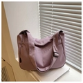 Detail of mauve nylon tote bag on a white windowsill showing side pocket and strap - Purple