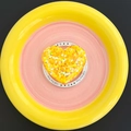 Detail of glitter-filled resin heart phone grip on a white Gift For You card tray - Yellow