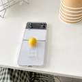 Detail view of transparent Z Flip case featuring a unique yellow spherical handle grip - Hard Shell - Spherical Ring / Yellow / Samsung ZFlip3