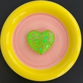 Detail shot of a green heart shaped resin phone socket with glitter sequins on a plate - Candy Heart - Green