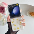 Detailed shot of transparent Z Flip phone case with real yellow daisies and silver glitter - Matte Hard Shell Style - Yellow Small Flowers / Samsung ZFold3