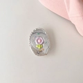 Detailed close-up of a floral glitter phone socket with a silver hammered metal edge - Purple Flower