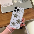 Detail of transparent iPhone case with silver starfish and heart charms in a lifestyle shot - Electroplated Silver Foil Wrinkled Star / iPhone 7/8/SE 2020