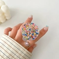 Close-up of a round glitter phone socket with stars and sequins on a user's hand - Colorful Pentagram Style (5)