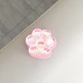 Primer plano de un soporte para móvil de pata de gato rosa iridiscente con corazón - Purpurina Láser Rosa