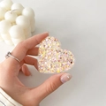 Detail of hand holding a heart-shaped phone grip with pink and yellow glitter inside - Colorful Glitter Heart No. 6