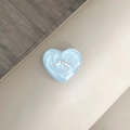 Macro detail of a 3D heart phone socket with a silver bow on pearlescent blue finish - Blue Flash / Labradorite