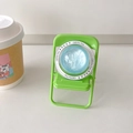 Detail of light green foldable chair phone stand with blue glittery gift disc - Blue Flash / Labradorite