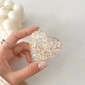 Close-up of heart-shaped Griptok with colorful sequins and acrylic finish on a phone - Colorful Glitter Heart No. 13