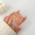 Detail of pink and gold glitter phone socket holder shown on hand with heart ring - Pink Gold Sequin Texture Style (12)