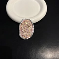 Detailed view of an oval pink and gold glitter folding cell phone stand with silver rim - Pink and Gold Mixed Glitter (No. 6)