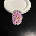 Close-up of heart shaped glitter phone grip with silver frame on ceramic plate - Pink and Yellow Gentle Glitter (No. 8)